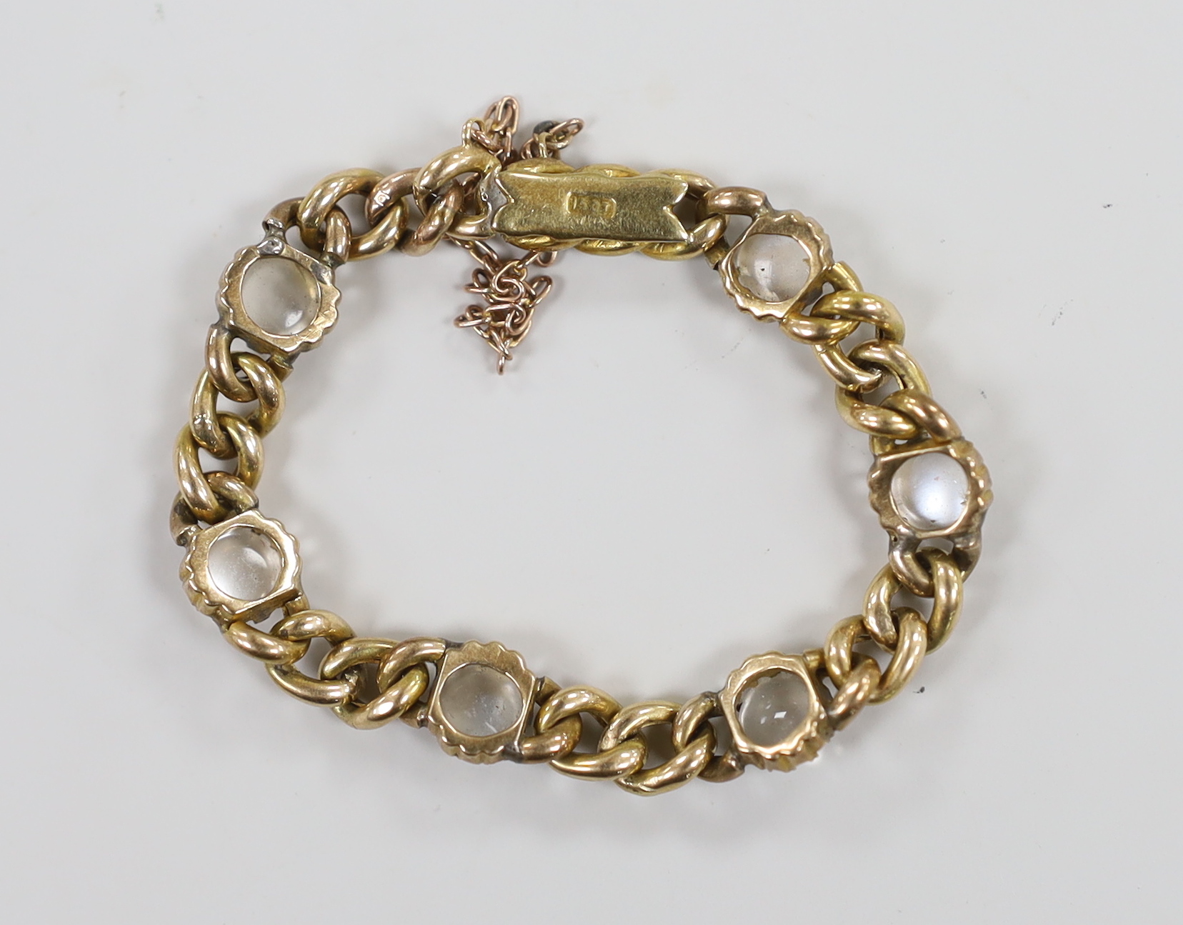 An Edwardian 15ct gold and six stone cabochon moonstone set child's curb link bracelet, 12cm, gross weight 9.3 grams.